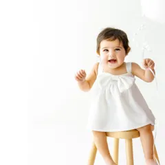 A simple white balloon adds a touch of whimsy to this sitter session. I love capturing these moments of pure, uninhibited joy as they discover new objects and textures.