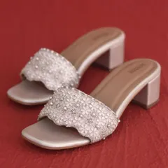 These block heels are detailed with delicate 3D flowers and pearls. They provide a comfortable lift, making them an ideal footwear choice for long hours of celebration during a mehendi or wedding.