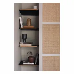 Memories on a wall. This small nook features corner shelves displaying curated books and objects. The textured wall paneling next to it adds another layer of detail, showing how we use every corner to add storage and personality.