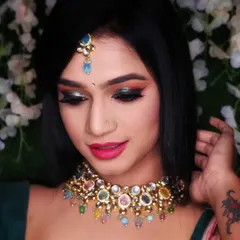 Another angle of this creative party makeup. The eyeshadow features a blend of warm tones with a pop of green glitter on the lid, creating a multi-dimensional effect that catches the light beautifully.