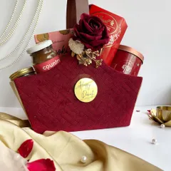 A luxurious deep red basket curated for Diwali. Filled with gourmet snacks and treats and adorned with a floral arrangement, this is a modern and elegant take on the classic festive gift basket.