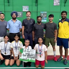 The coaches and a group of our younger summer camp participants. The sign says "Walk Tall, But Never Walk Backward," a motto we instill in our players.