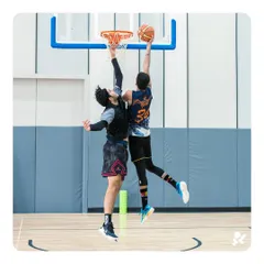 A player finishing high above the rim, perfectly framed by our professional-grade hoops and backboards.