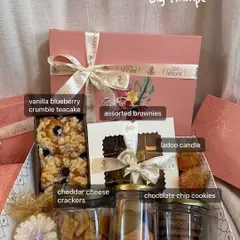 This is my big Diwali hamper, a truly generous gift. It includes a vanilla blueberry crumble teacake, assorted brownies, jars of cookies and crackers, and even some festive candles to complete the celebration.