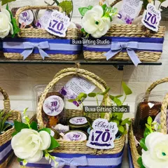 Cheers to 70 years. These limited edition birthday hampers were curated in handcrafted Kauna jute baskets with a mauve and white theme. They include a ceramic planter, assorted treats, scented candles, and a dry cake.
