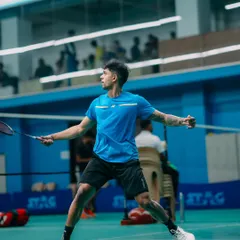 A player in a low, ready stance, anticipating the opponent's next move. This image showcases the focus and intensity that participants bring to the game.