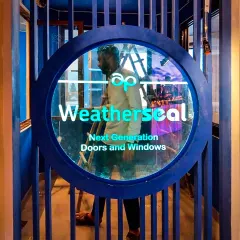 Custom branding is central to our experience center designs. Here, the 'Weatherseal' logo is integrated into a striking circular entryway, immediately immersing visitors in the brand's identity through bold colors and modern architectural signage.