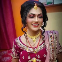 A radiant smile on a happy bride! I created this classic bridal look with bold red lips and defined eyes, complemented by a soft curly updo to complete her wedding day style.