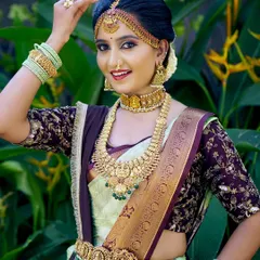 This bride is radiant in a light green and maroon silk saree. The makeup is kept fresh and glowing to complement the unique colour combination and antique gold jewellery.