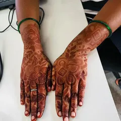 A stain check on a detailed design. You can see the rich, reddish-brown color that has developed, highlighting all the intricate patterns beautifully.