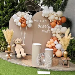 The "We can bearly wait" theme is perfect for a sweet and modern baby shower. This outdoor setup features a neutral color palette with beige, brown, and white balloons, pampas grass, and a cute teddy bear holding his own balloon bouquet.