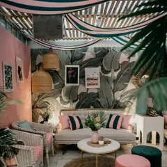 A full view of the "Hotel California" themed lounge area. The combination of the striped ceiling drape, Martinique wallpaper, and curated furniture created a truly immersive retro vibe.