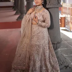 The full view of the light pink and silver lehenga, showing its graceful A-line silhouette and delicate work.