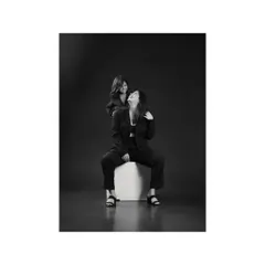 The contrast in this black and white photo is striking. A mother and daughter's shared laughter is captured with a dramatic, high-fashion feel, showing the modern side of family portraits.