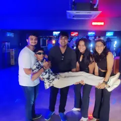 Enjoying every moment with the best squad. This group is having a blast, with one friend being playfully lifted by the others.