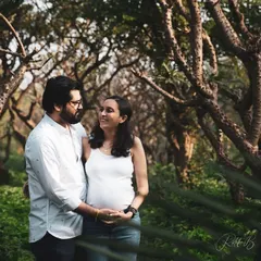 A walk through a wooded area provides a serene and natural backdrop for a maternity session. I love capturing these gentle moments where a simple glance between a couple says everything about their love and excitement.