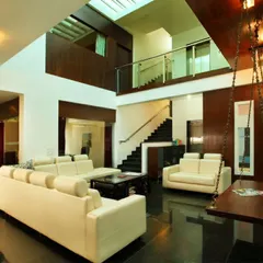Another perspective of the 'Courtyard Home', showing how the living spaces on different levels overlook the central atrium. The use of glass railings and open corridors ensures that the entire home feels like one cohesive, light-filled volume.