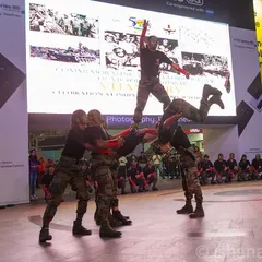 A dynamic shot of an Indian Army team forming a human pyramid during their performance at Cyberhub. For large public events, I focus on capturing impressive, coordinated action that showcases the scale of the celebration.