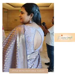 This elegant blouse features a beautiful keyhole back design, crafted from intricate lace fabric to match the client's Banarasi saree.