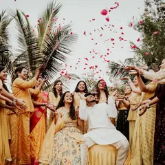A joyous moment as the couple is showered with flower petals by their friends and family during the Haldi function. These are the shots full of life and color.