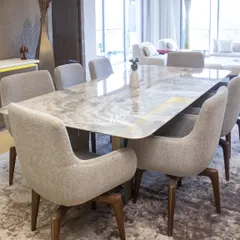 Here is our Elysian Marble Dining Table and Sora Dining Chairs in a Suncity residence we furnished. This project was about soft modernity, blending sculptural forms with tactile richness. The dining table's natural stone top with softly rounded corners, paired with the architecturally-inspired chairs, creates a space that is both grounded and effortlessly light.