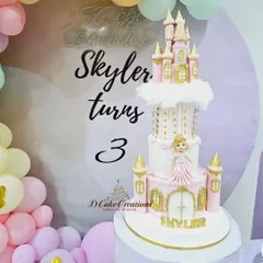 The princess castle cake as the stunning centerpiece of Skylar's 3rd birthday party, surrounded by pastel balloons.