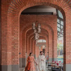We love using dramatic architecture to frame your story. Here, we used the repeating brick arches of the Avadh Utopia resort to create a sense of grandeur and a beautiful leading line, capturing the couple in a candid, walking pose that feels both epic and natural.