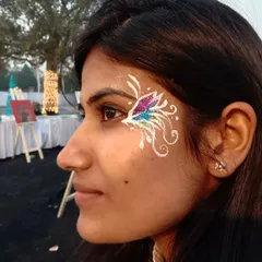 A whimsical design using white linework to create an abstract, airy butterfly. The multi-colored glitter in the center adds a beautiful pop of color that shifts in the light.