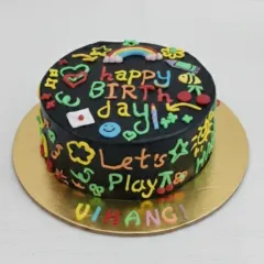 A fun and colorful doodle cake with a chocolate flavor. The black frosting provides a perfect canvas for vibrant, hand-piped doodles, making it a playful choice for any birthday.