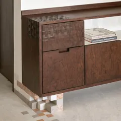 We love adding playful details where you least expect them. This burlwood media unit is grounded by pixel-like marble blocks, a detail that connects it to the geometric marble inlay on the floor, creating a cohesive design story.