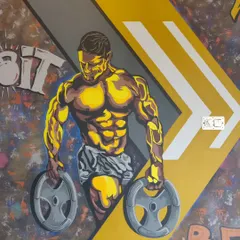 A close-up of the bodybuilder figure from our graffiti mural at One More Rep gym. The stylized, high-contrast look is designed to be motivating and energetic.