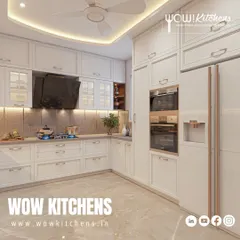 This angle highlights the integrated appliances, including the double oven and side-by-side refrigerator, which are seamlessly incorporated into the classic cabinetry.
