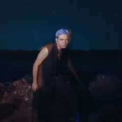 An artistic shot from an editorial project where I handled men's grooming. The concept involved creating a futuristic look with bold, temporary blue hair color that stands out against the dark, atmospheric background.