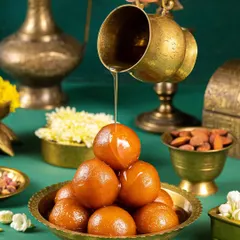 There's nothing more tempting than a bowl of gulab jamuns. I captured the moment just as the sugar syrup is poured, highlighting the glossy texture and making them look absolutely irresistible.