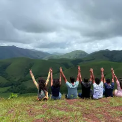 This is what pure happiness looks like. A moment of joy with fellow trekkers on the rolling grasslands of Kudremukha, with a massive view of the mountains behind us.