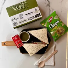 Perfect for a lighter option, this snack box features a fresh vegetable sandwich with a side of mint chutney. Paired with chips and ketchup, it's a simple yet popular choice for corporate meetings and school events.