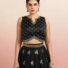 A close-up of the black Pichwai lehenga blouse, featuring a V-notch neckline and delicate embroidery.