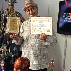 Holding an award at an exhibition, surrounded by my art. Each recognition is a milestone that encourages me to push the boundaries of eco-art.