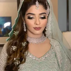 A stunning Walima look for Farheen. The makeup features a silver-toned smokey eye and a matte nude lip to complement her ethereal mint green outfit.