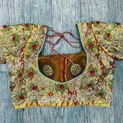 A fully embroidered blouse with a mix of silver and red threadwork on a gold base. The design includes floral and leaf patterns with bead highlights for a festive look.