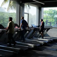 Our cardio section features a line of treadmills overlooking a green view, providing a pleasant environment for your warm-ups and endurance training.