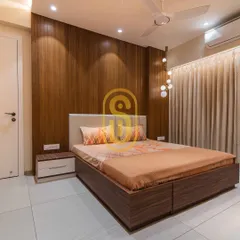 This bedroom design uses warm wood paneling to create a cozy and inviting atmosphere. The globe pendant lights add a modern, sculptural element to the room.
