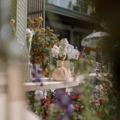A close-up of the floral details from a spring luncheon. We used a mix of wildflowers in simple glass and ceramic vases, creating a look that is effortlessly chic and full of natural beauty.