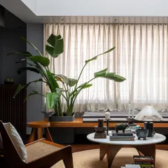 Another view of the master bedroom lounge, showing how we curate moments for relaxation. A classic Pierre Jeanneret easy chair and a collection of books and objects create a perfect corner to unwind by the window.