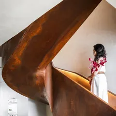 At our Terra Gardens penthouse project, the staircase is more than a functional element; it is a piece of art. Crafted from a single piece of Corten steel, its sculptural form creates a striking focal point that contrasts beautifully with the home's minimalist, monochromatic palette.