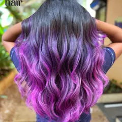 We call this the 'molly melt'. A beautiful balayage that blends from a natural dark root into a vibrant amethyst purple and then into a hot pink, creating a stunning sunset effect.