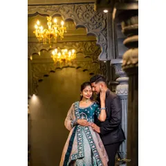An intimate embrace in a grand, beautifully lit hall. The couple's elegant attire and the architectural details create a luxurious and romantic photo.