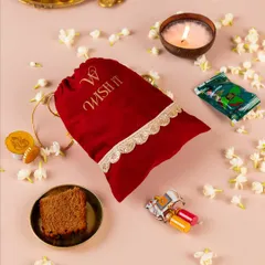 My modern take on a timeless tradition, the "Thamboolam Tales" potli. It’s filled with thoughtful items like a coconut candle, paan-flavored chocolates, and a mini Ganesha holder, making it a memorable wedding favor for guests.
