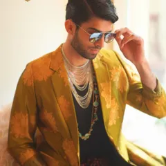 For me, men's styling has no boundaries. I created this look with a mustard gold brocade overcoat and silk velvet tie-dye pants to show that luxury menswear is all about confident layering and breaking the rules.