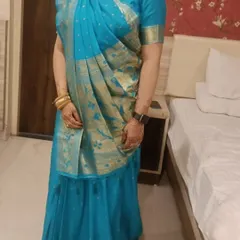The final look of the pre-pleated Gujarati style saree. The front pallu drape is set perfectly, providing an elegant and traditional appearance without the difficulty of draping it from scratch.